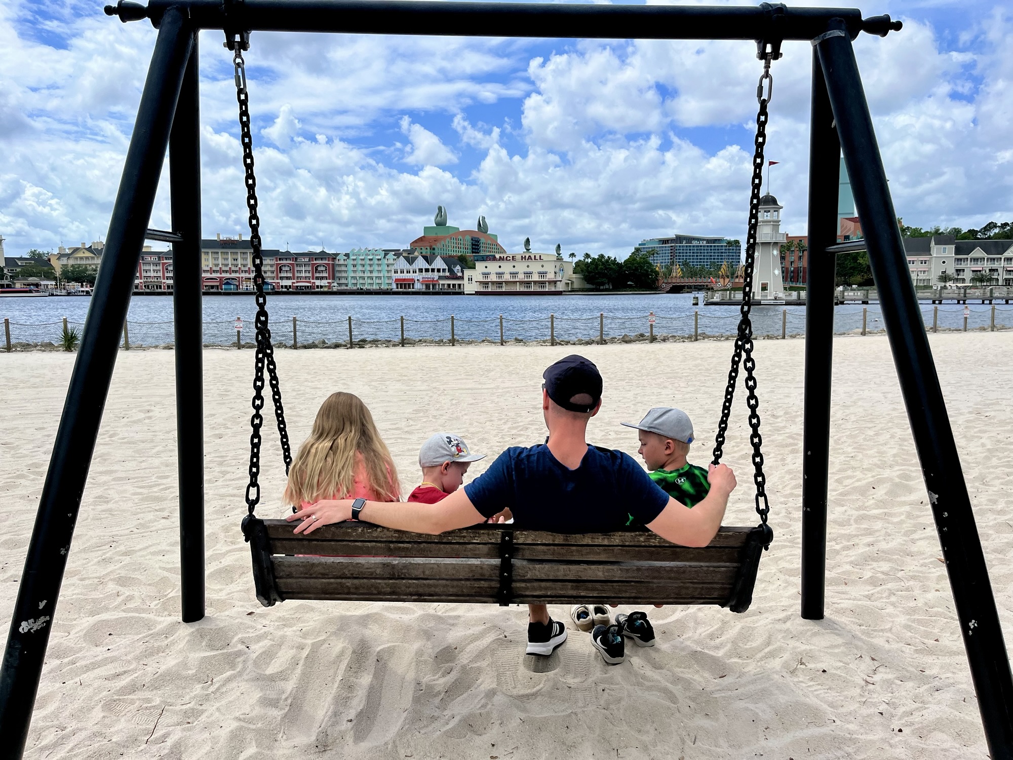 swinging on a bench on a beach facing the Boardwalk outside Beach Club Resort in Disney World